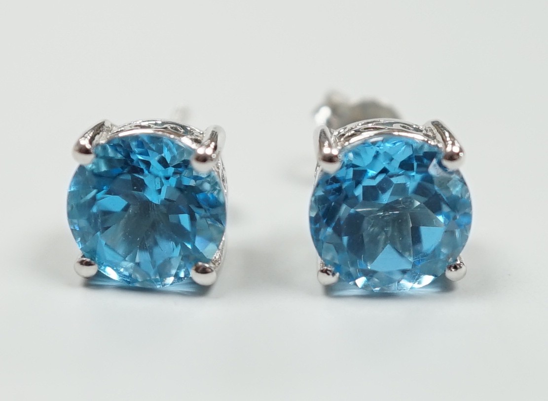 A modern pair of white metal (stamped 18) and single stone blue topaz set ear studs, 7mm, gross weight 3.1 grams.